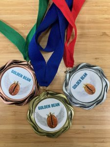 3 medals from Golden Bean The Americas, a bronze, gold, and silver.