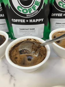 Coffee Cupping example showing how to break the crust with a spoon