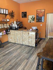 Cafe and tasting lab space with orange walls and bags of coffee on shelves